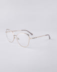 A pair of Ada eyeglasses from For Art's Sake® is set against a plain white background, showcasing their sleek and minimalist wireframe design. These frames feature thin metal arms with a stainless steel core and a subtle nose bridge.