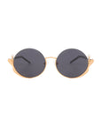 Ariel sunglasses by For Art's Sake® feature round dark lenses, gold-colored frames with decorative upper corner accents, and black temples for a chic finish.