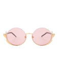 The Ariel sunglasses by For Art's Sake® feature round gold frames, pink lenses, wing details, and pearl accents for a mermaid-inspired, fashionable touch to any outfit.
