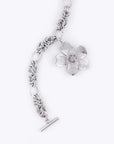 The Blossom Bracelet by For Art's Sake® is a silver chain bracelet with an intricate floral design, measuring 20.5 cm in length. It features a detailed flower pendant and is secured with a toggle clasp, set against a plain white background.