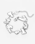 The Forms Bracelet by For Art's Sake® features abstract organic silver links, joined with small rings and finished with a lobster clasp plus an adjustable chain—ideal for layering. Shown against a white background.