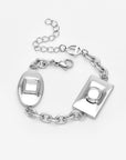 The Geometry Bracelet by For Art's Sake® is a modern silver chain bracelet with oval and rectangular geometric charms featuring raised designs, an adjustable extension chain, and a lobster clasp, shown on a plain white background.