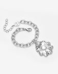 The Shell Pendant Bracelet by For Art's Sake® is a silver chain bracelet with an adjustable clasp, featuring a large leaf-shaped pendant and a central freshwater pearl—a striking piece of coastal jewellery.