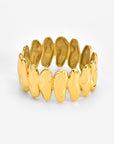 The Forms Bangle by For Art's Sake® showcases interlocking, irregular gold links with a polished finish, elegantly arranged in a circular band and set against a white background.