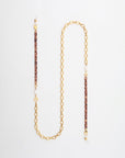 A stylish gold-plated eyewear chain with alternating links of brown braided material and freshwater pearl embellishments evenly spaced along its length, creating an elegant and modern design. The **Tokyo Glasses Chain** by **For Art's Sake®** is laid flat on a white background.