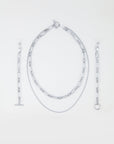 A Vienna Glasses Chain by For Art's Sake®, featuring an oval link necklace with a toggle clasp, a shorter fine chain necklace, a bracelet with a toggle clasp, and a bracelet with a ring clasp—all arranged neatly on a light background. The collection's 18-karat gold-plating adds an elegant touch to each piece.