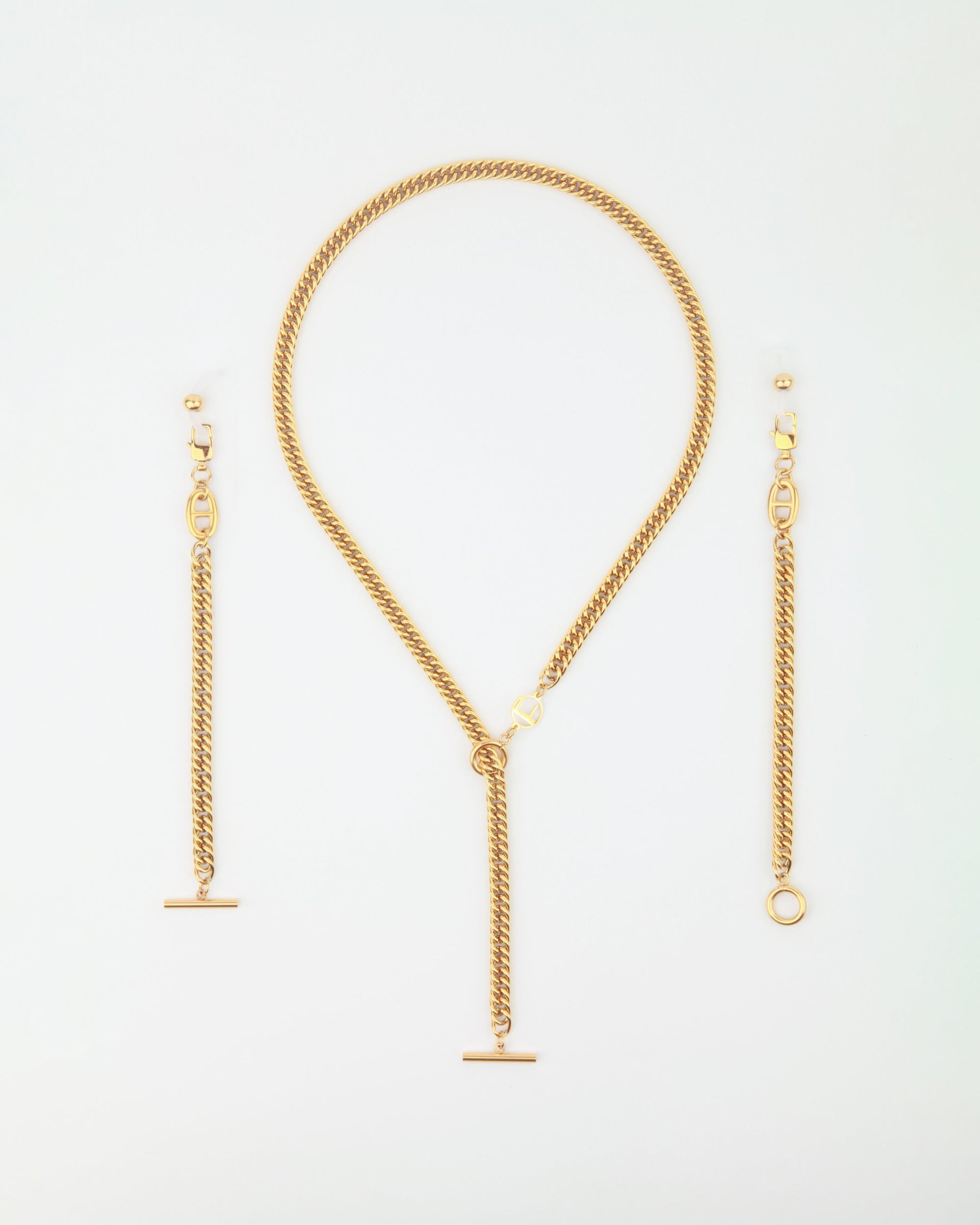 A Lisbon statement necklace with a Y-shaped pendant and matching earrings by For Art's Sake®. The 18-karat gold Lisbon necklace features a sleek chain with a bar pendant hanging from the Y-joint. The earrings are chains with bar pendants and small circular detailing, mirroring the necklace's design.