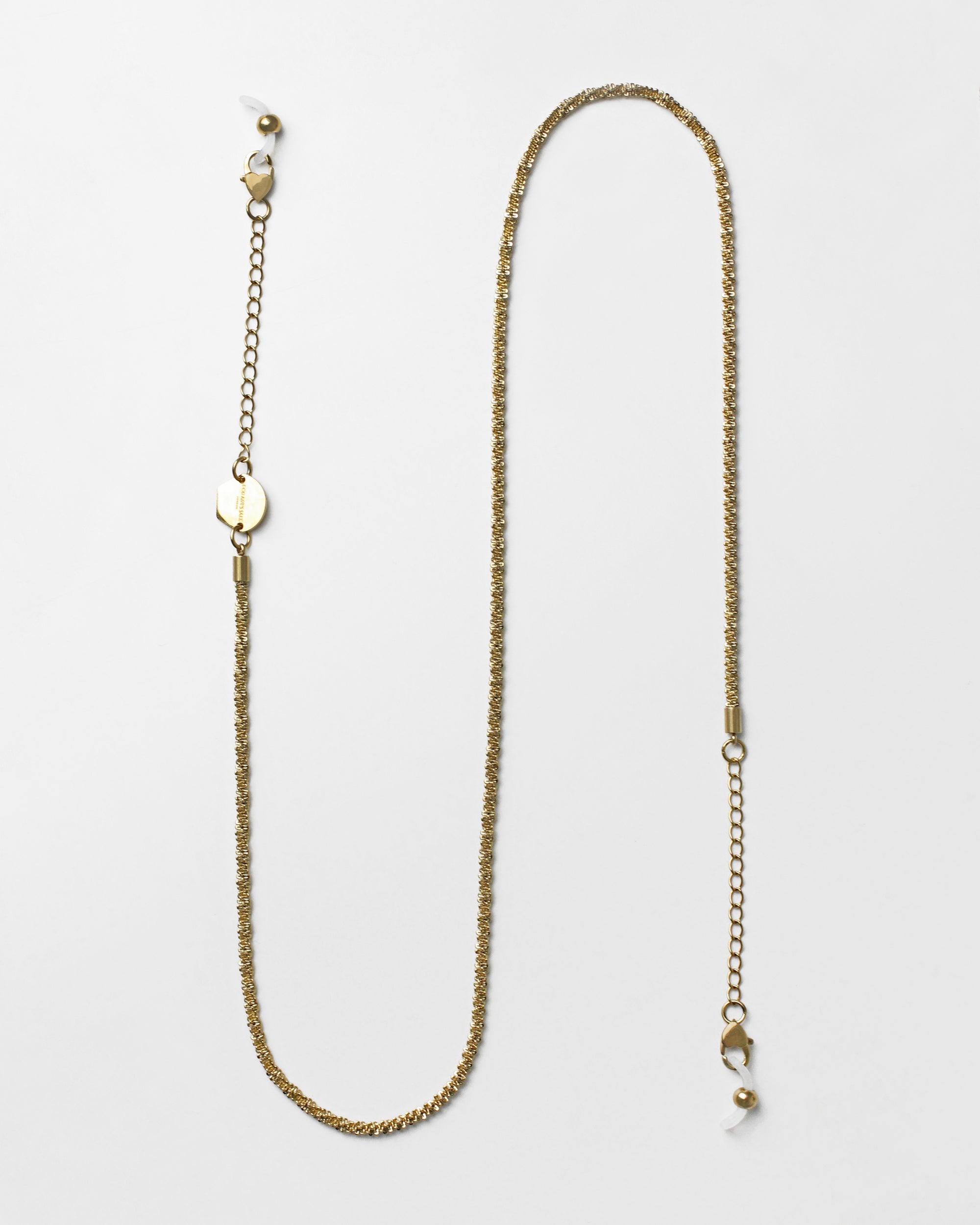 A delicate, 18k gold-plated **Mayfair Glasses Chain** with fine, intricate links and heart-shaped claw closures at both ends, designed to attach to eyeglasses. The chain also features adjustable extension links for a customizable fit. Displayed against a plain white background. Brand: **For Art's Sake®**