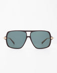 A pair of stylish black sunglasses with a rectangular frame and dark green lenses. The For Art's Sake® Cinnamon Green sunglasses feature unique 18-karat gold-plated accents near the hinges, adding a touch of luxury to the design. The background is plain white.