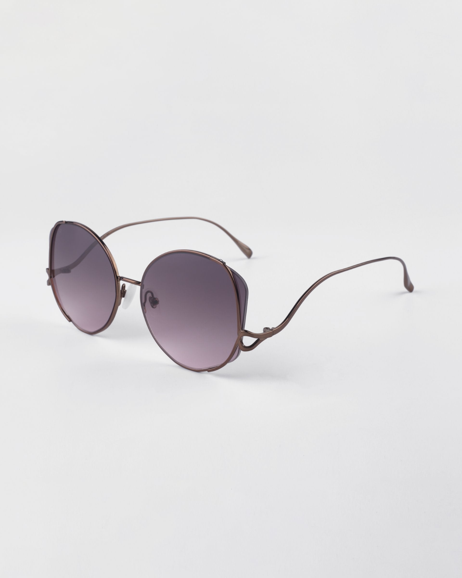 For Art's Sake Canvas sunglasses in Rose. Side view of glasses showing the rose gold metal frames and round shape.
