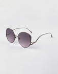 For Art's Sake Canvas sunglasses in Rose. Side view of glasses showing the rose gold metal frames and round shape.