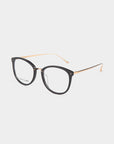 A pair of Club eyeglasses by For Art's Sake® featuring black, rounded frames and thin gold temples. The glasses have clear lenses with a blue light filter and a minimalist design, set against a plain white background.