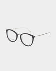 A pair of eyeglasses from For Art's Sake®'s Club collection, featuring round, black frames and thin, silver temples with curved earpieces. The lenses are clear with a built-in blue light filter, and the glasses are set against a plain white background.