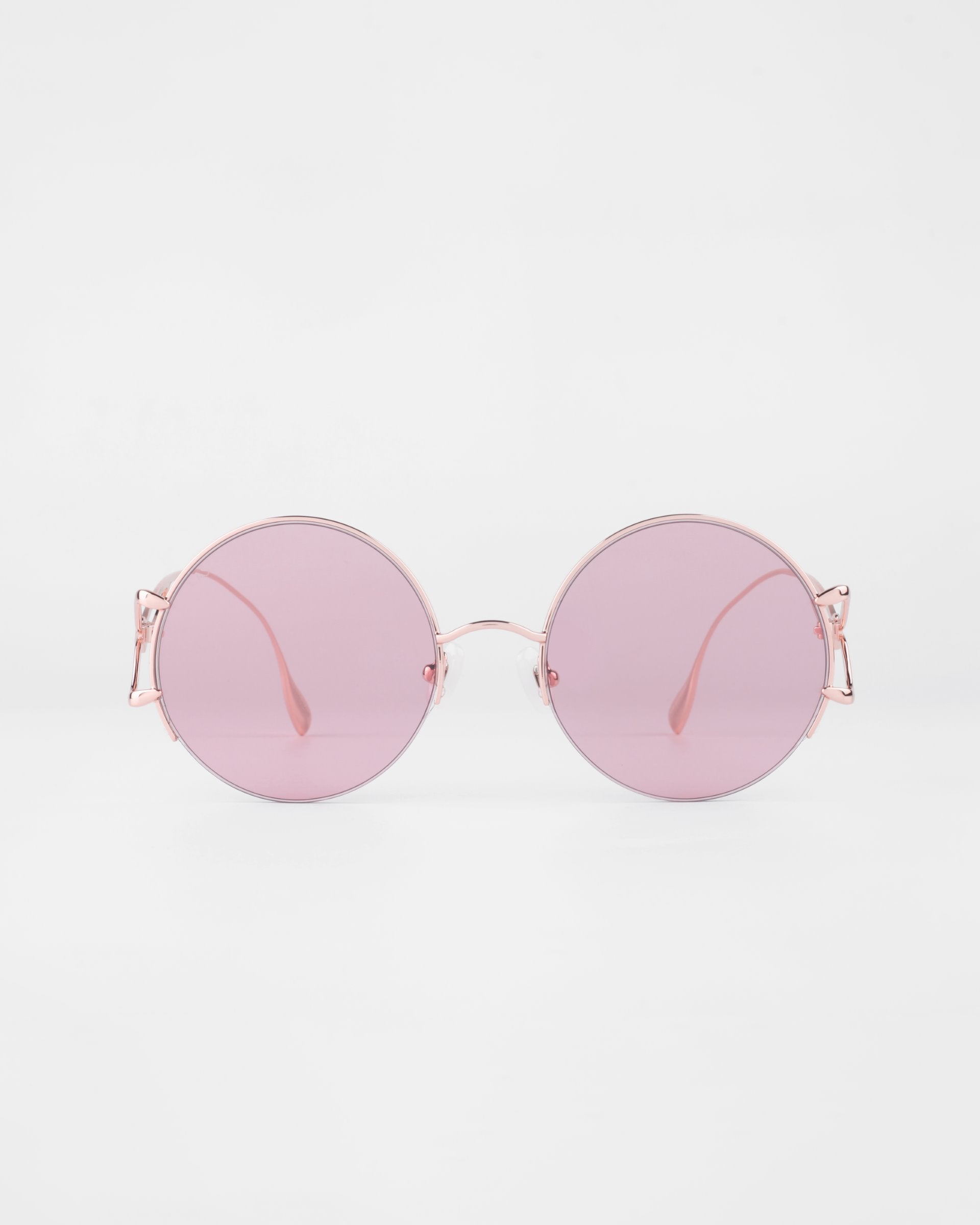 The For Art's Sake® Diptych - Pink sunglasses feature thin pink metal frames, light pink lenses, jadestone nosepads for comfort, and UV protection. Only 2 left. Displayed on a plain white background.