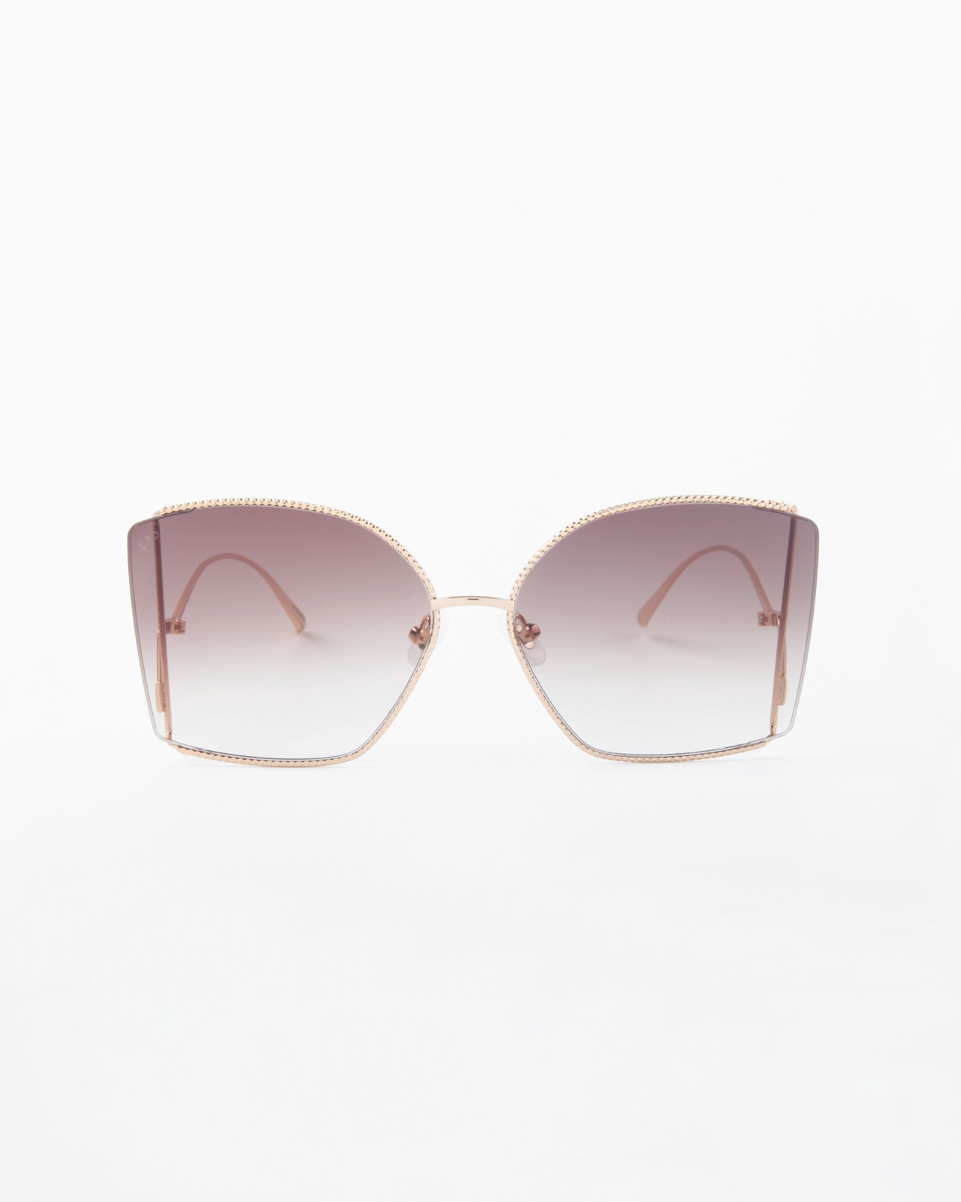 Front view of a pair of For Art's Sake® Dixie oversized, square sunglasses with gradient lenses that transition from brown to clear. The handmade gold-plated frames are thin and metallic, with a delicate, minimalist design. Equipped with UV protection and shatter-resistant nylon lenses for durability and style.