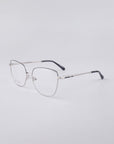 Displayed against a light gray background, the elegant Dora frames by For Art's Sake® are crafted with a stainless steel core. These eyeglasses feature a thin wire-frame design with rectangular lenses and black temple tips.