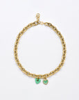 A For Art's Sake® Double Heart Necklace Gold featuring double hearts; one is a solid green charm and the other is a green outlined heart encrusted with small stones. The necklace has a lobster clasp closure.
