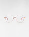 A pair of eyeglasses with large, round lenses and thin, light pink frames. The brand name "For Art's Sake®" is written in small letters on the left lens. Featuring a blue light filter, these Dumpling glasses are displayed against a plain, white background.