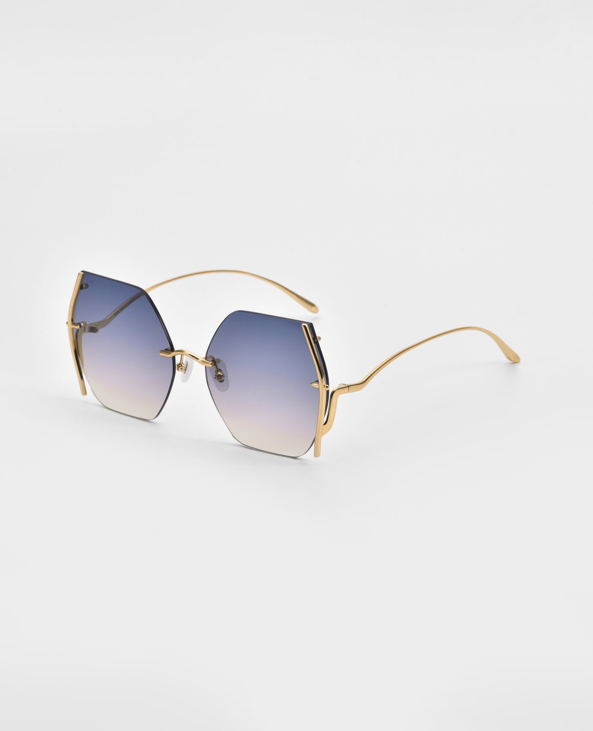 A rare Generation Topaz by For Art's Sake®—stylish sunglasses with gold metal arms and large, rimless square lenses fading blue to clear, UV protection. Only 1 available, elegantly displayed on a white surface.