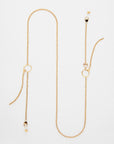 A long 18K gold-plated chain necklace with two geometric-shaped pendants and beaded accents. The adjustable loops and clasp provide a perfect fit. The minimalist, sophisticated design is laid out against a plain white background, similar to the Florentina Glasses Chain by For Art's Sake®.