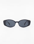 A pair of black oval-shaped Frida Portrait sunglasses by For Art's Sake® with dark tinted, ultra-lightweight nylon lenses is centered on a white background. Both arms of the sunglasses are folded, and they offer 100% UVA & UVB protection.