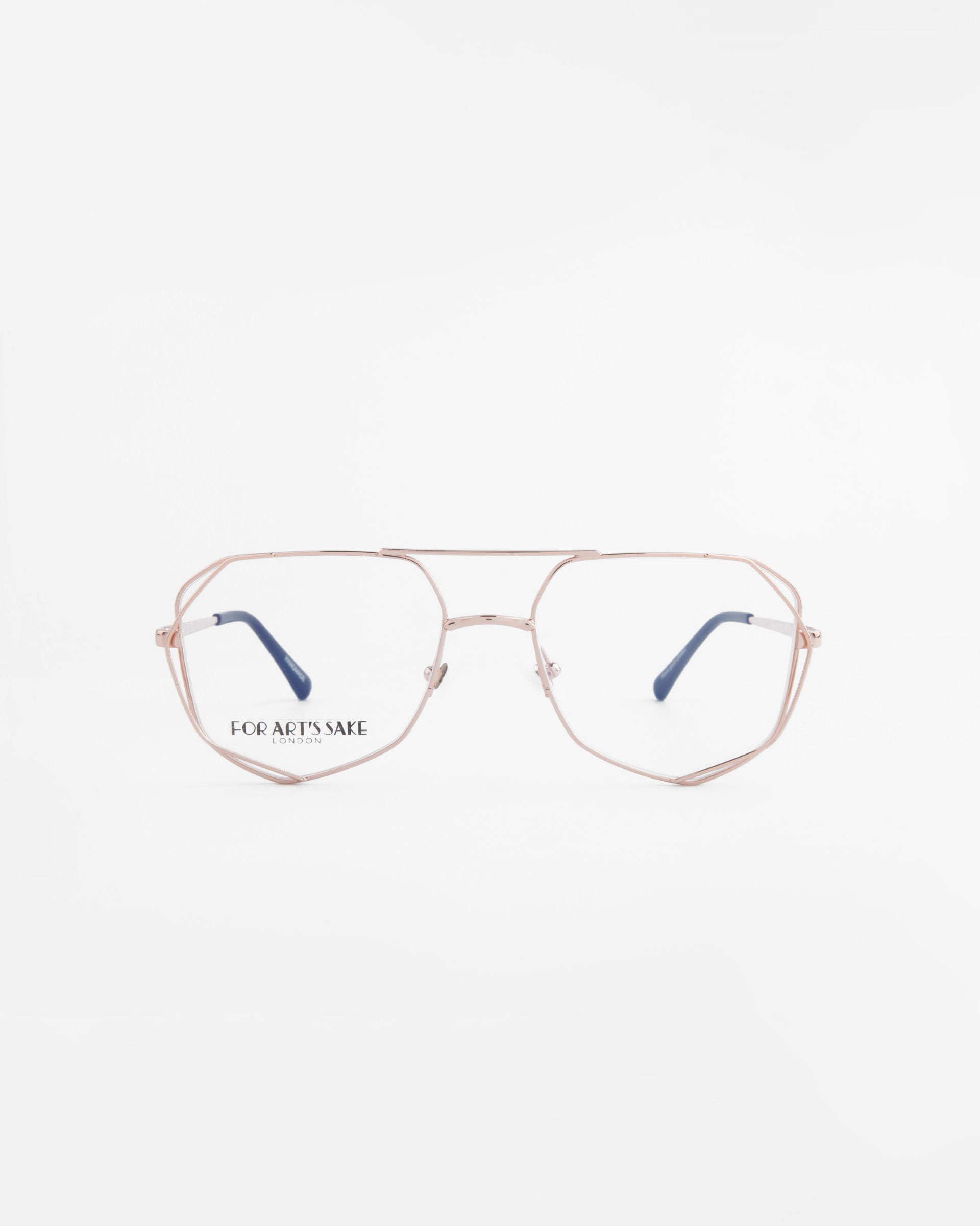 A pair of stylish Genius Two eyeglasses by For Art's Sake® with gold-toned metal frames and clear lenses that offer UV protection. The design features a double bridge and slightly geometric shape. The temple tips are black. The words "For Art's Sake®" are inscribed on the left lens.