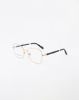 The Grace eyeglasses by For Art's Sake® are meticulously crafted with 18-karat gold, featuring rectangular lenses and black temple tips. The handmade frame is showcased against a plain white background.