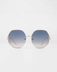For Art's Sake® Hera (LAST ONE): Hexagonal oversized sunglasses with thin gold frames and gradient blue lenses, shown on a white background. Adjustable nosepads and gently curved arms add comfort and style.