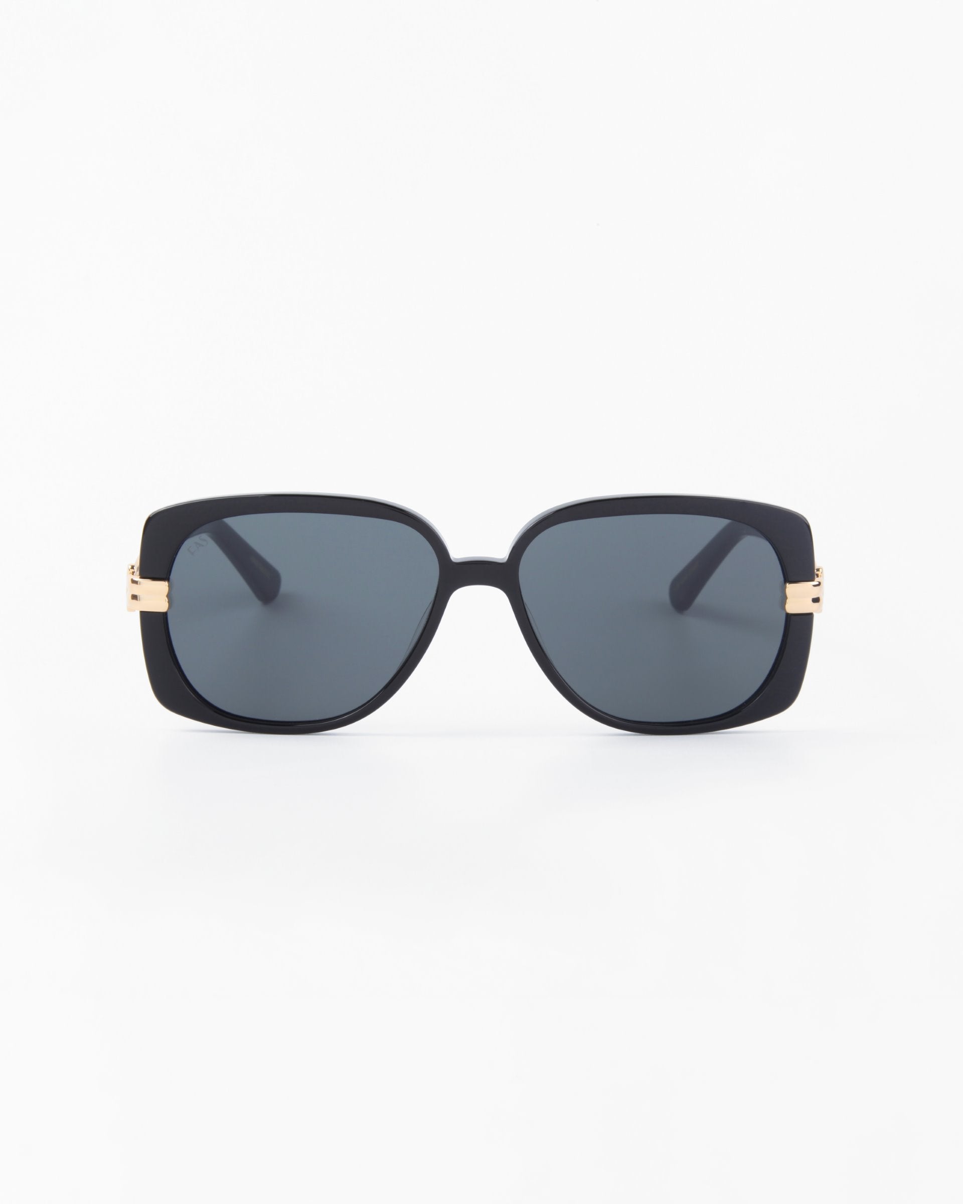 The Icon-ARC by For Art's Sake® are sleek D-frame sunglasses with UVA & UVB protection. They feature black handmade acetate frames, dark tinted lenses, and luxurious gold accents near the hinges set against a minimalist white background.