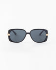 The Icon-ARC by For Art's Sake® are sleek D-frame sunglasses with UVA & UVB protection. They feature black handmade acetate frames, dark tinted lenses, and luxurious gold accents near the hinges set against a minimalist white background.