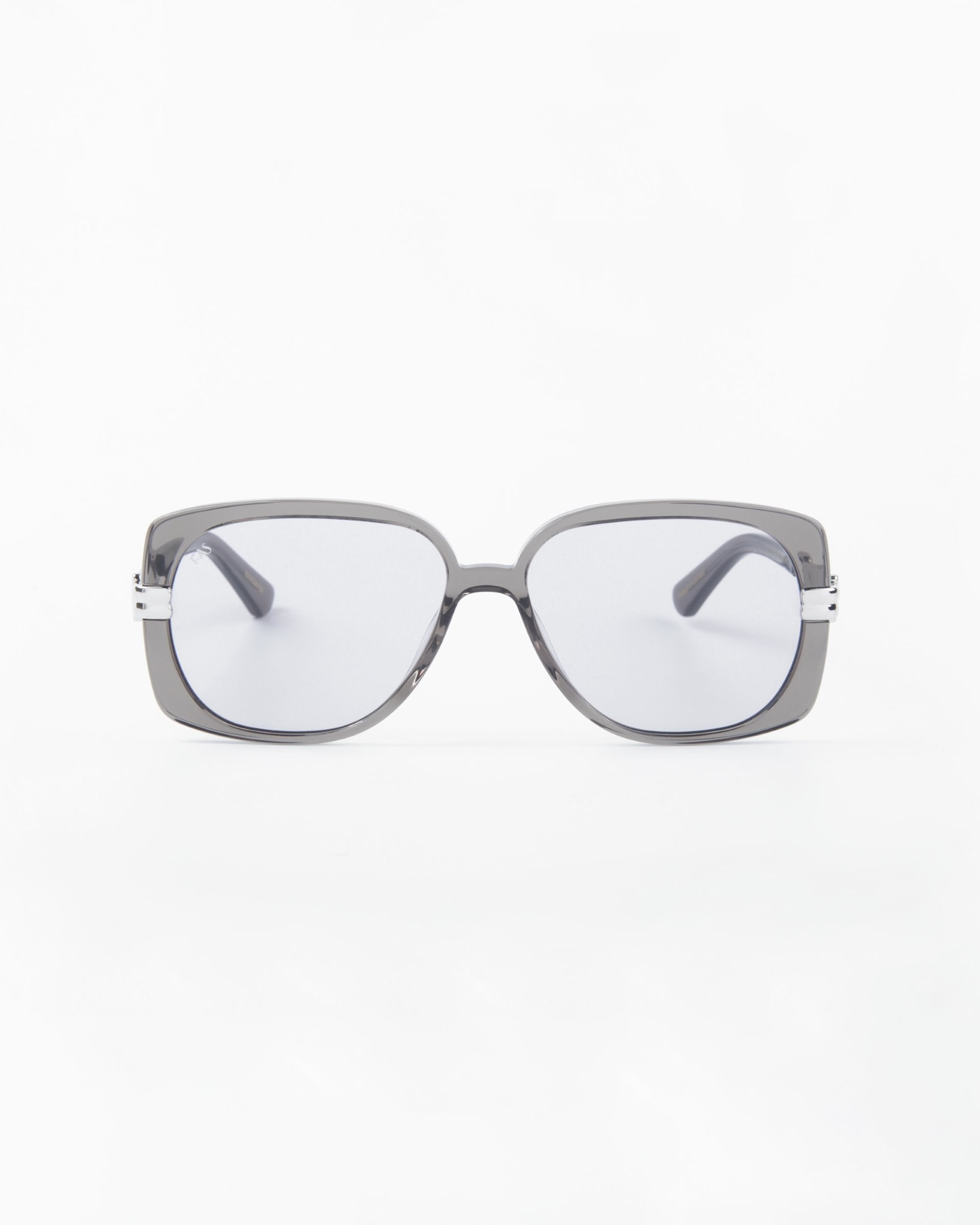 Front view of Icon- ARC, a pair of handcrafted sunglasses by For Art's Sake®, showcasing square gray acetate frames and dark lenses with UVA & UVB protection against a plain white background.