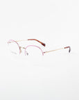 Here is the sentence with the specified product name and brand name:
A pair of For Art's Sake® Ivy minimalist eyeglasses with thin gold frames and subtly tinted pink upper rims. The temples are gold with brown tips. Featuring clear prescription lenses with a blue light filter, the overall design is sleek and modern against a plain white background.