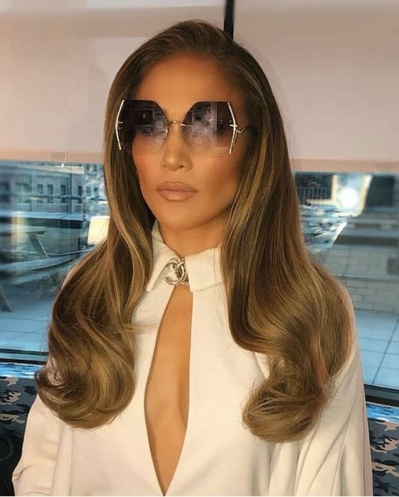Jennifer Lopez JLO embodies a Snow Queen look, styled in designer For Art’s Sake Generation sunglasses and a stunning designer gown.