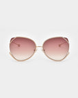 For Art's Sake® Wonderland sunglasses feature large round frames in thin gold, jadestone nose pads, and gradient pink lenses with 100% UV protection. Shown on a plain white background.