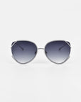 For Art's Sake® Wonderland sunglasses feature an oversized silver metal frame, jadestone nose pads, and dark gradient lenses with 100% UV protection, shown on a white background.