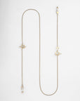 A long, elegant 18kt gold-plated Little Venice Glasses Chain by For Art's Sake® is laid flat on a white background. The chain features opulent star charms and abstract geometrical pendants evenly dispersed along a delicate gold chain. One end has a small spherical clasp for closure.
