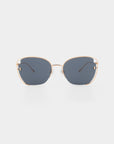 A pair of For Art's Sake® Eden sunglasses with 18-karat gold plated frames and dark blue-tinted, UVA & UVB-protected lenses viewed from the front against a white background. The frames have a slight curve at the top and thin temples with black tips.