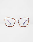 A pair of brown, large, square-rimmed glasses with gold-colored arms and purple inner tips. The transparent lenses showcase the brand text "For Art's Sake®" on the left lens. Featuring 18-karat gold-plated frames, the Lace glasses are positioned against a plain white background.