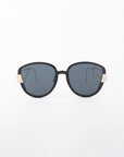 A pair of large, black-framed Mars sunglasses with dark, shatter-resistant nylon lenses and gold-plated stainless steel accents on the temples by For Art's Sake®. The background is plain white, highlighting the sleek and modern design of these UVA & UVB-protected sunglasses.