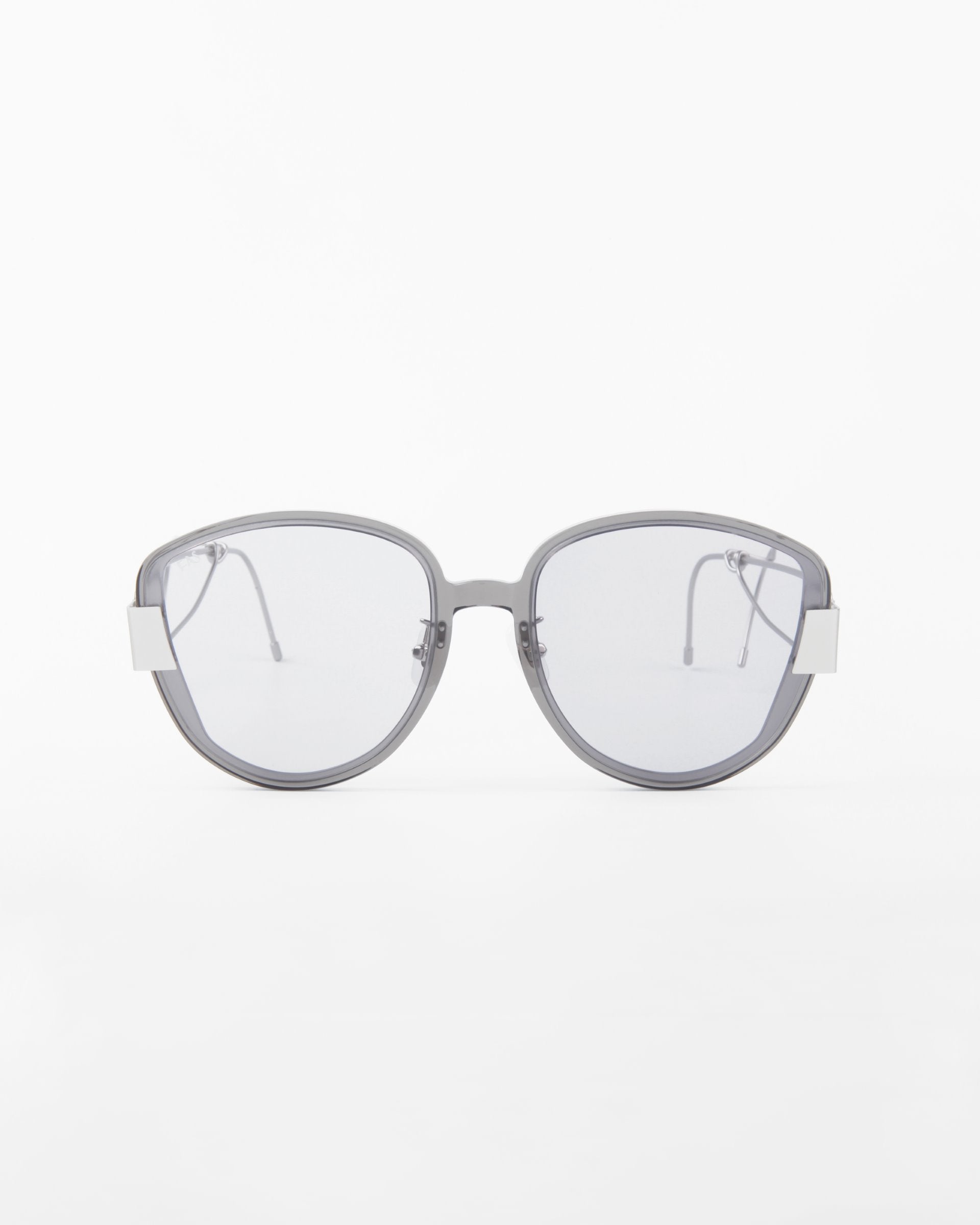 A pair of modern, round, gray Mars eyeglasses from For Art's Sake® with translucent, shatter-resistant nylon lenses and white accents on the temples. The sleek and minimalistic frame is crafted from gold-plated stainless steel, set against a plain white background.