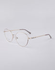 A pair of For Art's Sake® Millie frames, showcasing a thin metal build and round lenses, is set against a light gray background. These eyeglasses exemplify a sleek, minimalist design with blue light filter lenses, adjustable nose pads, and cushioned temple tips for maximum comfort.