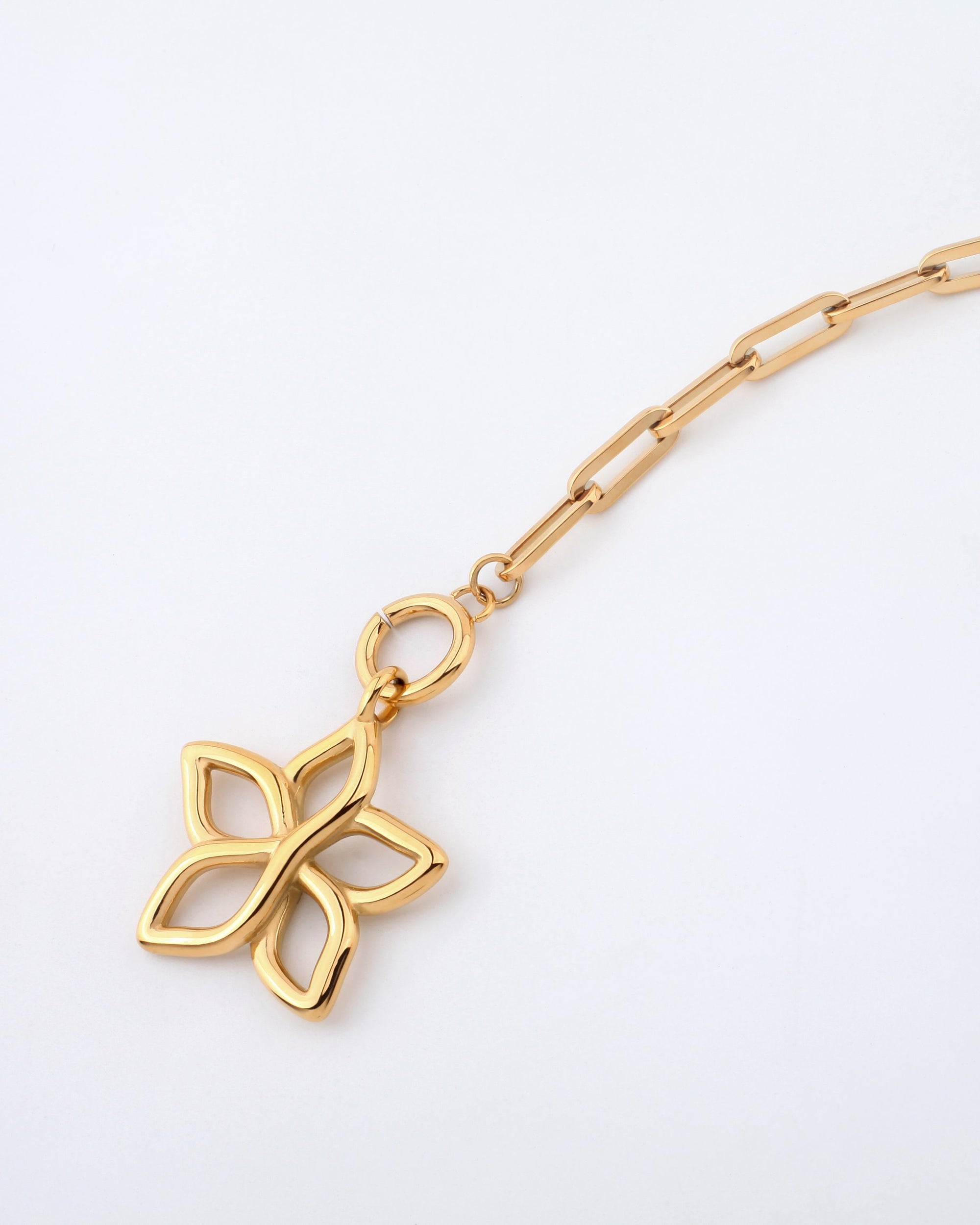 A close-up image of the 49cm Plumeria Necklace by For Art's Sake®, showcasing its elegant gold chain link design and a pendant shaped like a four-petal flower with open spaces inside each petal, set against a plain white background.
