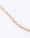 Introducing the Raya Necklace by For Art's Sake®, a stunning 24-karat gold chain featuring oval links and alternating light pink segments, elegantly showcased against a plain white background. This statement piece is perfect for adding a touch of sophistication to any outfit.