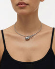 A model wears The Rose Choker by For Art's Sake® with a black spaghetti strap top, set against a plain white background.