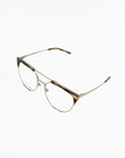 A pair of Frosty by For Art's Sake® prescription glasses with clear round lenses, thin gold metal frames, and tortoiseshell detailing on the top rims. The temples are thin and gold, with tortoiseshell accents at the tips. These stylish glasses, also equipped with blue light filter technology, are set against a white background.