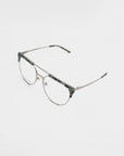 A pair of For Art's Sake® Frosty prescription glasses featuring thin metallic frames with a camouflage-patterned brow line and bridge. The earpieces are slim and also metallic, with matching camouflage accents on the tips. The clear, rectangular lenses offer both UV protection and a blue light filter for added eye comfort.