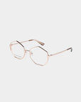 A pair of rose gold For Art's Sake® Antidote glasses featuring heptagon-shaped clear lenses. The minimalist design boasts thin metal arms with black tips at the ends, and the glasses are positioned on a white background. Jade gemstone nose pads add a touch of luxury to this elegant accessory.