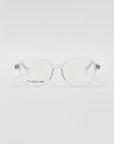 A pair of For Art's Sake® Charm transparent framed optical glasses in a cat-eye shape on a white background, with a visible brand name etched on one lens.