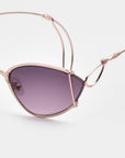 Close-up of For Art's Sake® Ornate sunglasses with almond-shaped lenses, an artistic wire design, edgy rose gold metal frame, and dark purple tints, set against a plain white background.