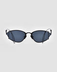 A pair of Ornate sunglasses from For Art's Sake® in a black-framed, cat-eye design with dark lenses is displayed against a plain, white background. These sunglasses feature thin temples, offer reliable UVA & UVB protection, and boast a vintage style combined with a modern, stylish design.
